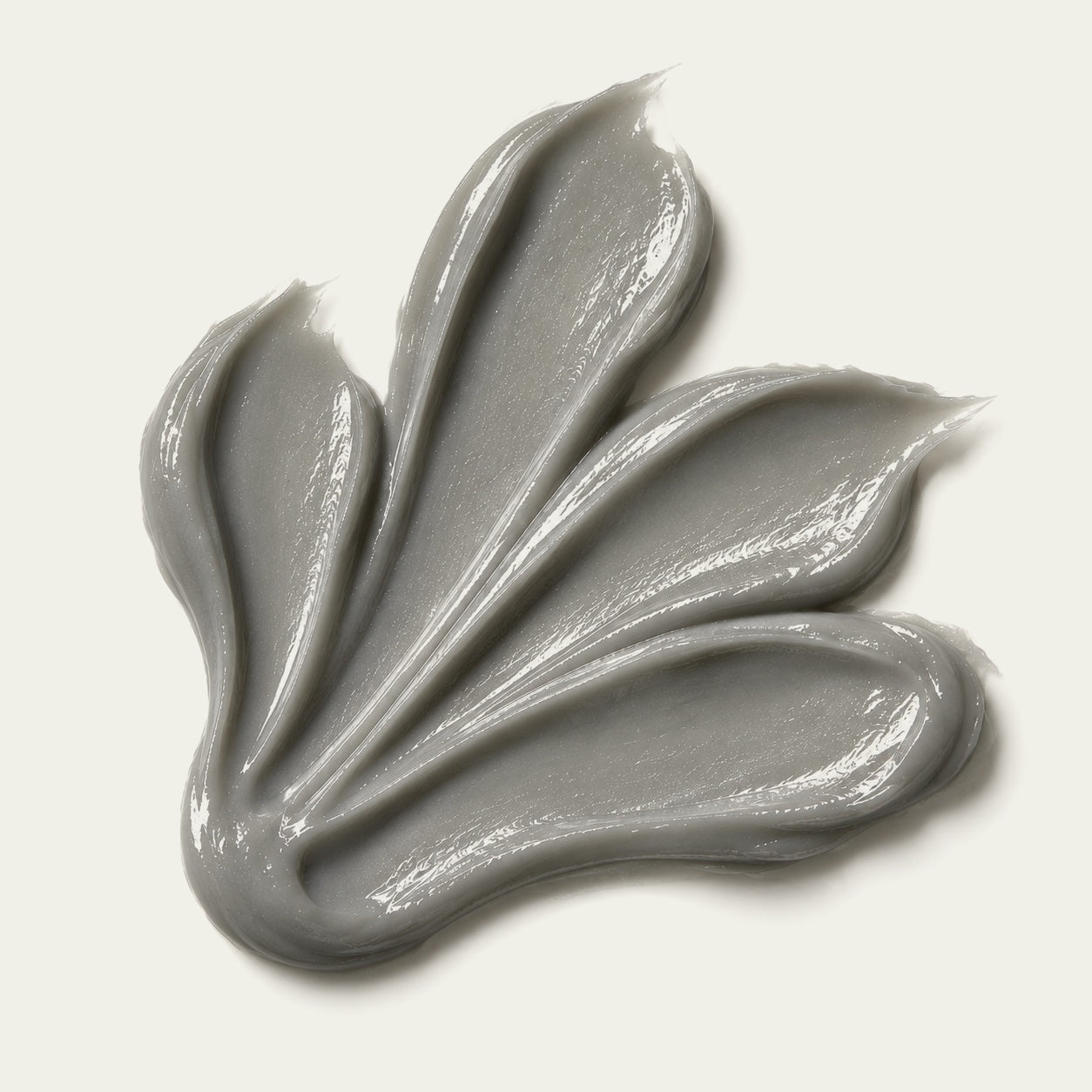 A swatch of BVIC, the grey concentrate, spread on a warm background